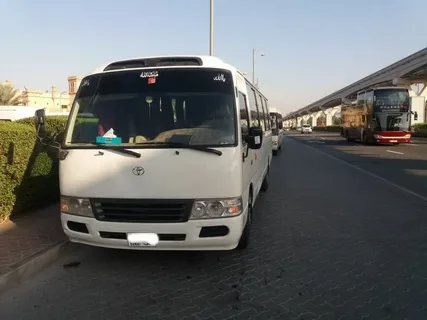 A white colour minibus on a road